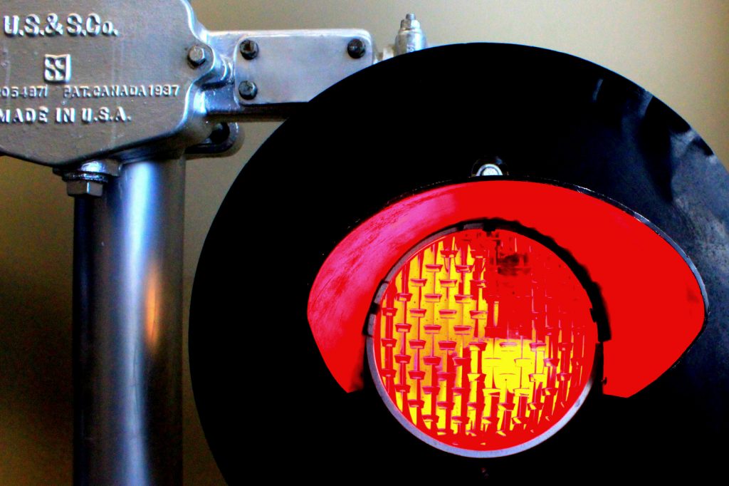Close-up photo of a red lighted railroad signal.