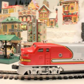 Trains of Christmas with Santa Fe engine cruising.
