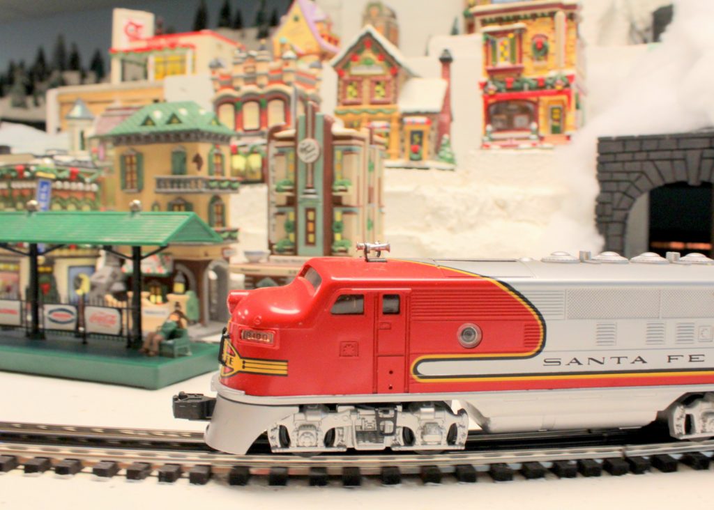 A train locomotive passing by - Christmas at the Roundhouse" model train display.