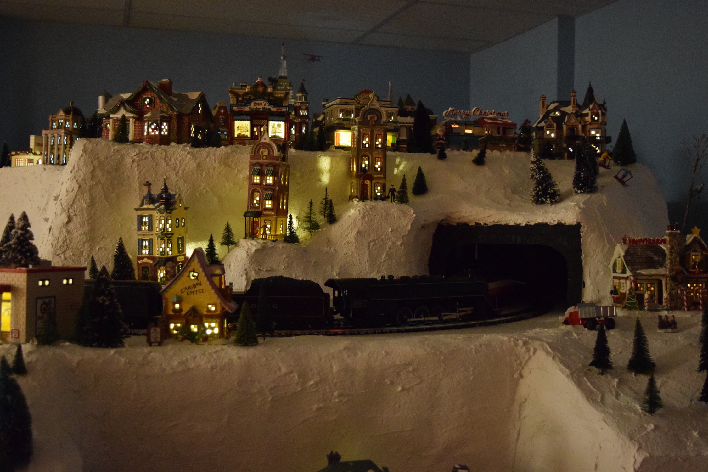 A winter scene at night in town - Christmas at the Roundhouse" model train display.