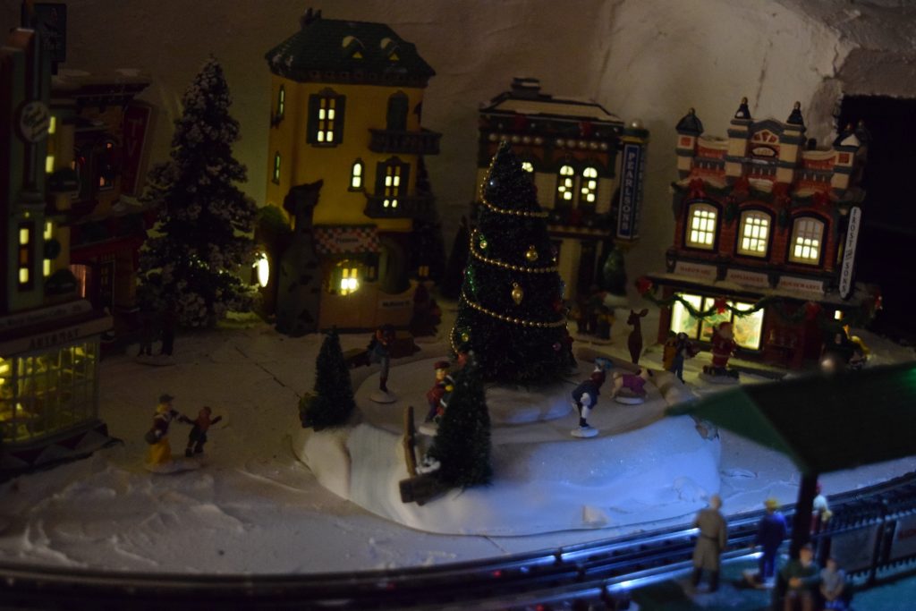 A winter scene at night in town - Christmas at the Roundhouse" model train display.