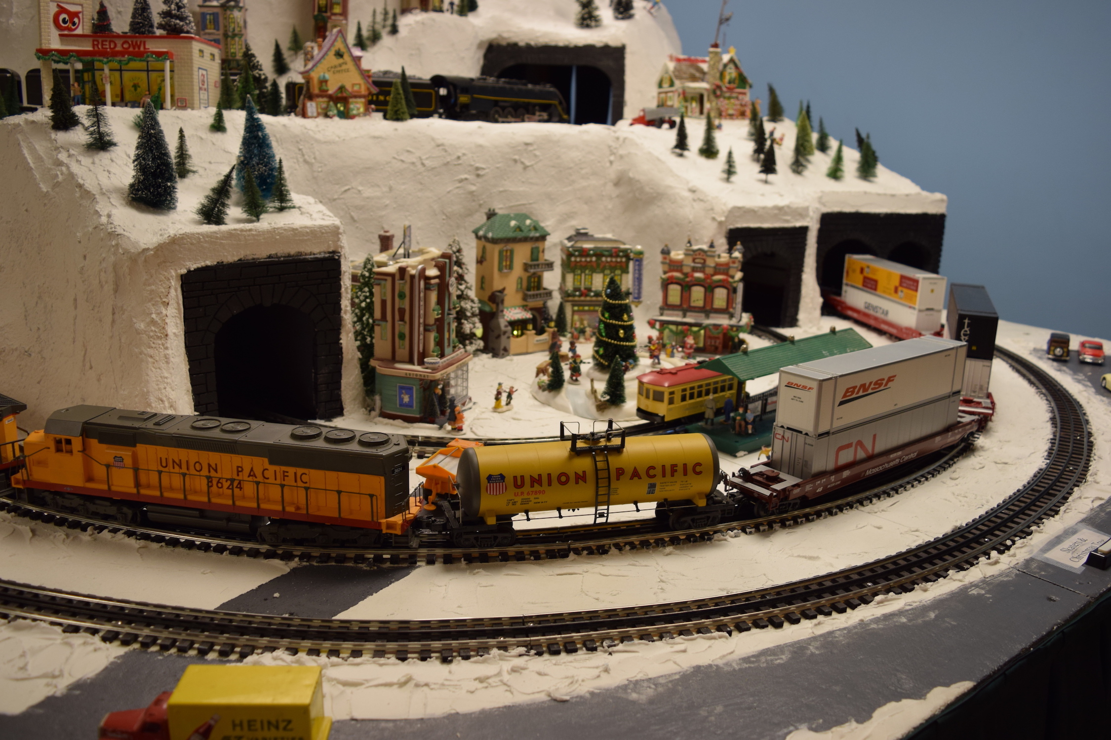 A freight train coming around the bend - Christmas at the Roundhouse" model train display.