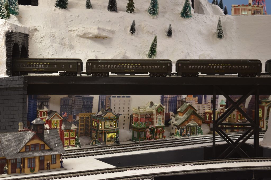 Passenger cars on overpass over town - "Christmas at the Roundhouse" model train display.