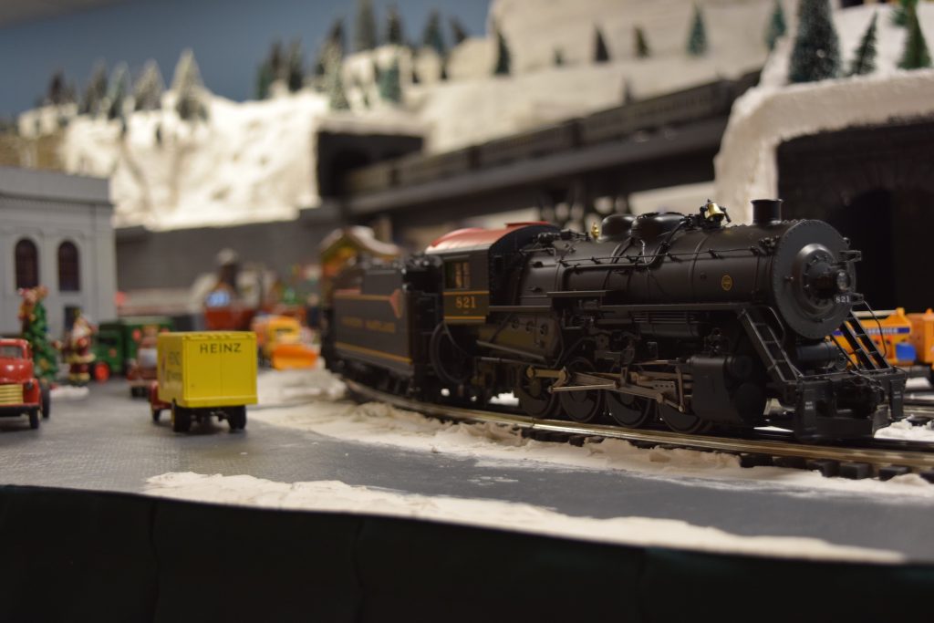 A steam locomotive passing by - "Christmas at the Roundhouse" model train display.