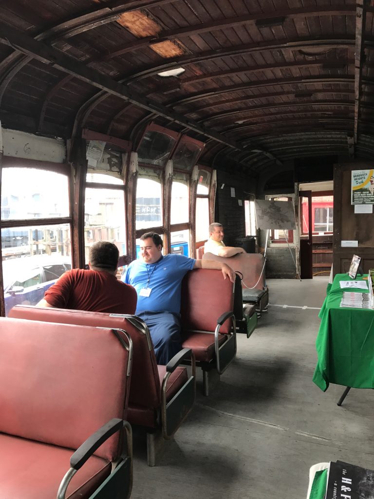 Interior photo of the Trolly with people sitting in passenger seats, rolling stock of the Hagerstown Roundhouse Museum during Railroad Heritage Days.