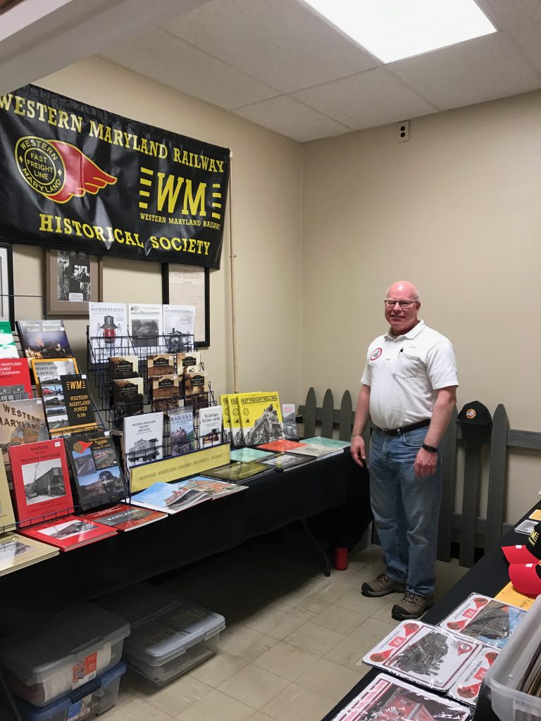 Publication display with male attendant – interior room of the Hagerstown Roundhouse Museum during Railroad Heritage Days.